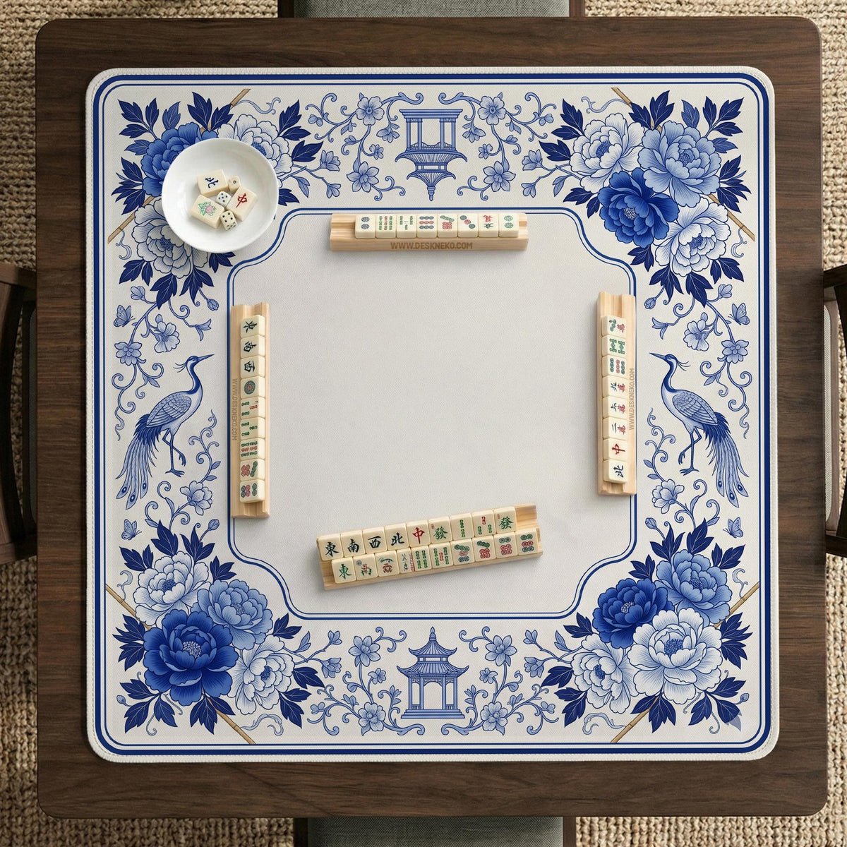 Square blue and white mahjong mat with peonies, cranes, pagoda accents, and chinoiserie linework around a plain center.