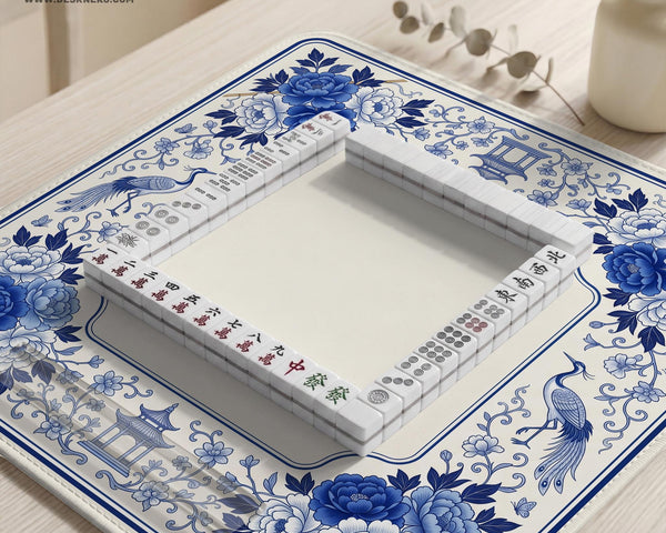Square blue and white mahjong mat with peonies, cranes, pagoda accents, and chinoiserie linework around a plain center.