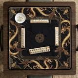 Black mahjong table mat with a gold dragon border, gold geometric corner details, and a clear center play area.
