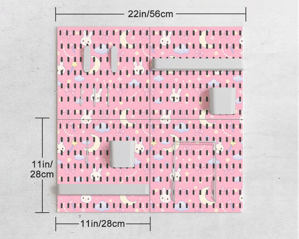 Pink pegboard panels with a kawaii bunny, cloud, moon, bow, and star pattern shown as a wall organizer set.