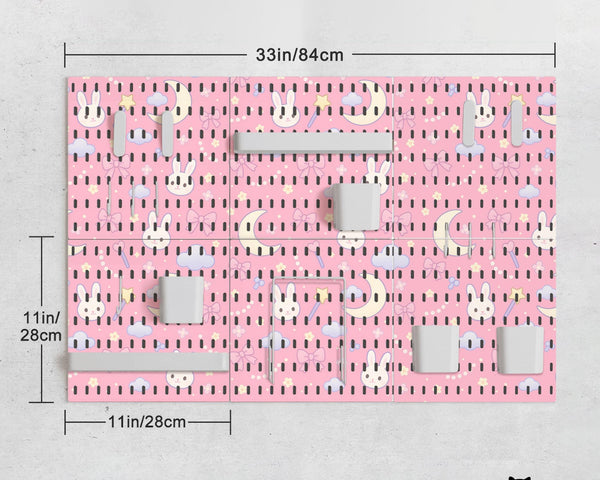 Pink pegboard panels with a kawaii bunny, cloud, moon, bow, and star pattern shown as a wall organizer set.