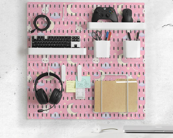 Pink pegboard panels with a kawaii bunny, cloud, moon, bow, and star pattern shown as a wall organizer set.