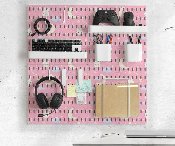 Pink pegboard panels with a kawaii bunny, cloud, moon, bow, and star pattern shown as a wall organizer set.