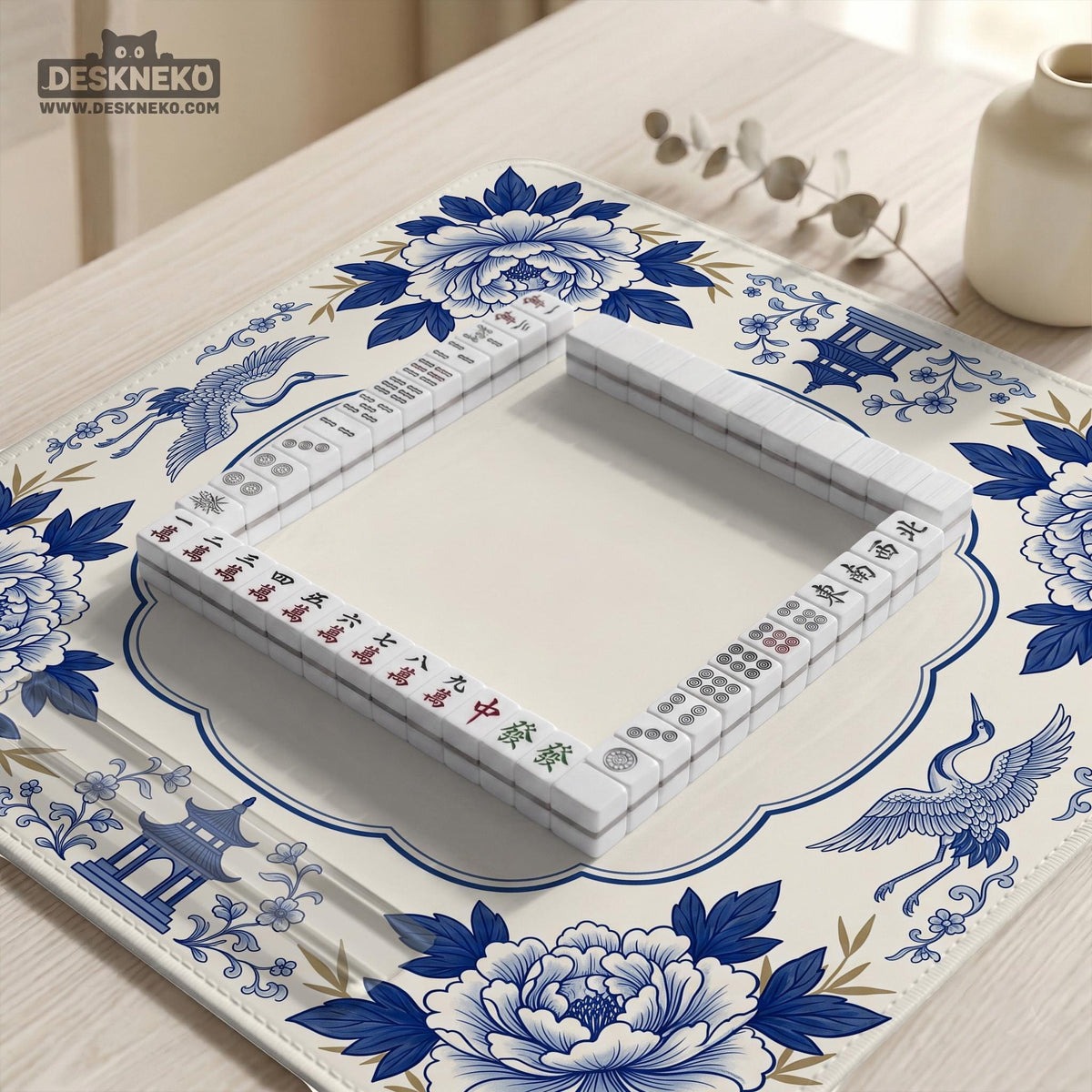 Blue and white mahjong mat with cranes, floral porcelain-style artwork, a cream center area, and a decorative border.