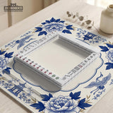 Blue and white mahjong mat with cranes, floral porcelain-style artwork, a cream center area, and a decorative border.
