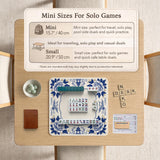 Blue and white mahjong mat with cranes, floral porcelain-style artwork, a cream center area, and a decorative border.