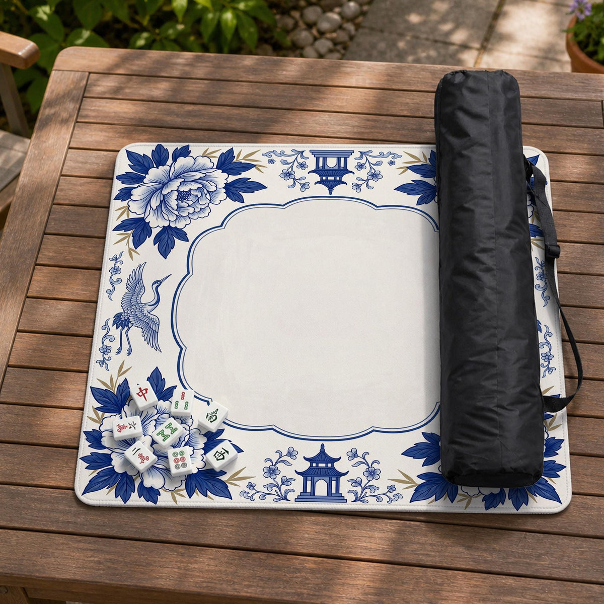 Blue and white mahjong mat with cranes, floral porcelain-style artwork, a cream center area, and a decorative border.