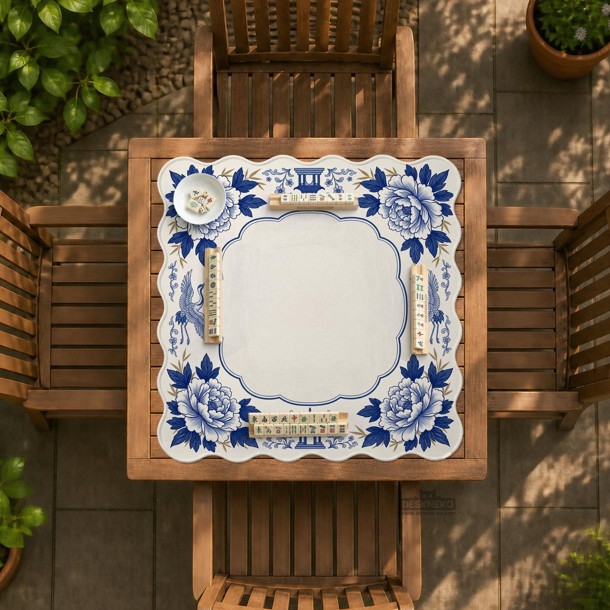 Blue and white mahjong mat with cranes, floral porcelain-style artwork, a cream center area, and a decorative border.