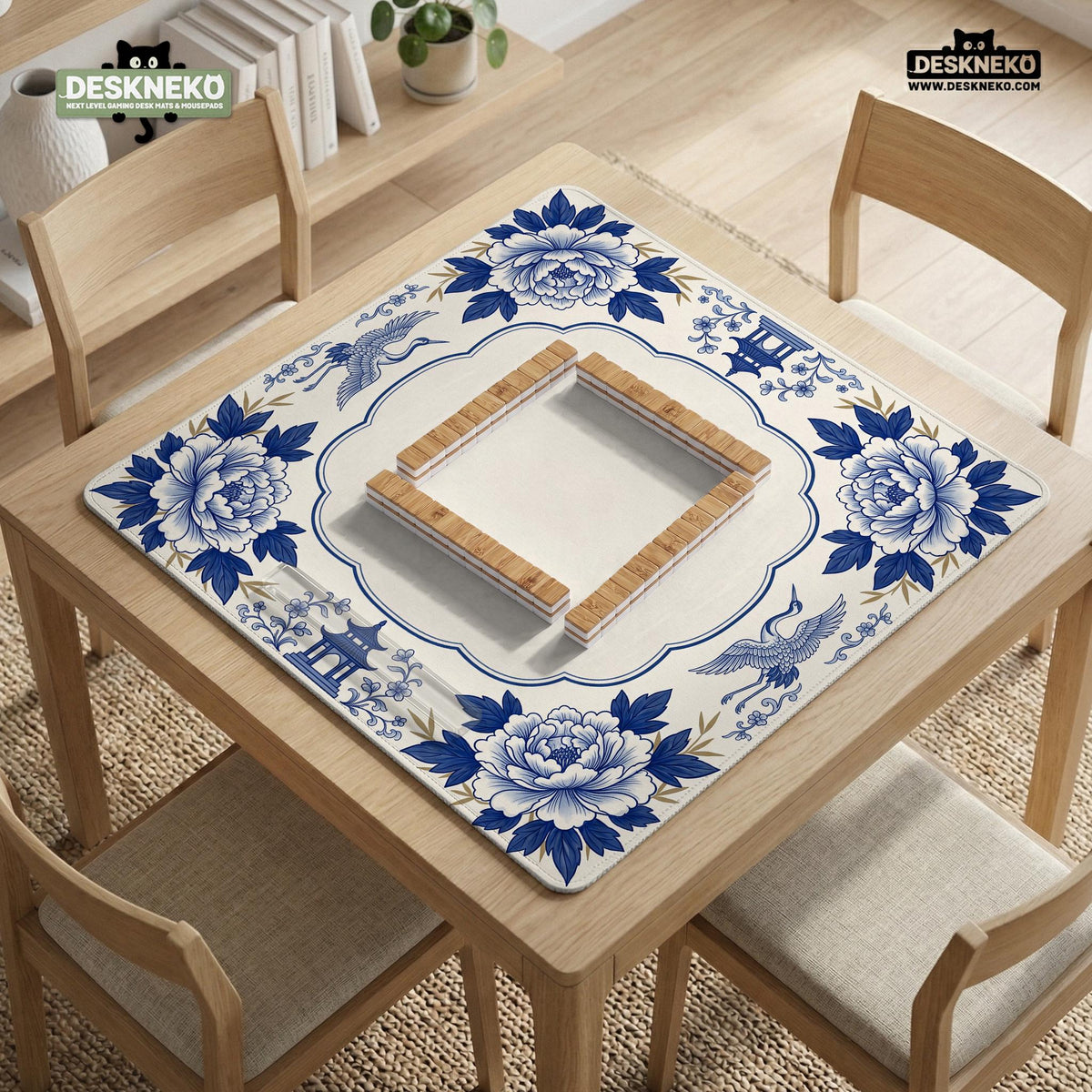 Blue and white mahjong mat with cranes, floral porcelain-style artwork, a cream center area, and a decorative border.