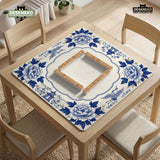 Blue and white mahjong mat with cranes, floral porcelain-style artwork, a cream center area, and a decorative border.