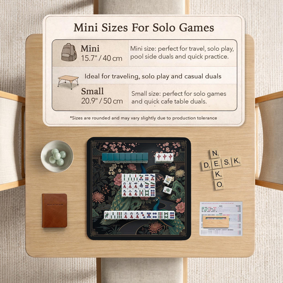 Square black mahjong mat with a gold peacock, blush flowers, and dark botanical artwork on a dark background.