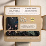 Square black mahjong mat with a gold peacock, blush flowers, and dark botanical artwork on a dark background.