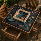 Square black mahjong mat with a gold peacock, blush flowers, and dark botanical artwork on a dark background.