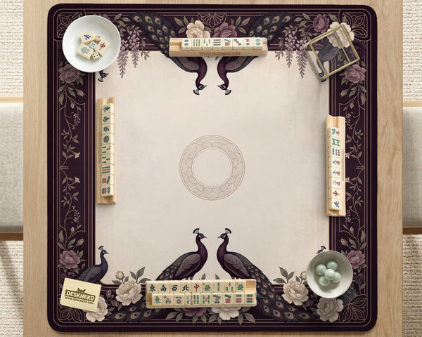 Square mahjong mat with a dark plum border, ivory floral pattern, muted sage leaves, and a decorative peacock garden design.