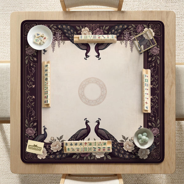 Square mahjong mat with a dark plum border, ivory floral pattern, muted sage leaves, and a decorative peacock garden design.