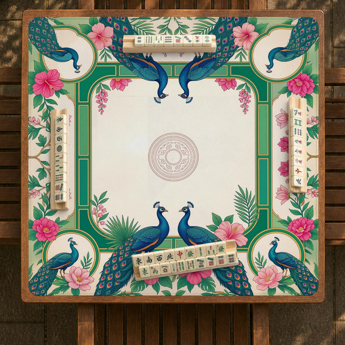 Green mahjong mat with peacocks, hibiscus flowers, tropical leaves, cream center space, and a scalloped floral border.
