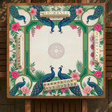 Green mahjong mat with peacocks, hibiscus flowers, tropical leaves, cream center space, and a scalloped floral border.
