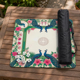 Green mahjong mat with peacocks, hibiscus flowers, tropical leaves, cream center space, and a scalloped floral border.
