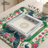 Green mahjong mat with peacocks, hibiscus flowers, tropical leaves, cream center space, and a scalloped floral border.