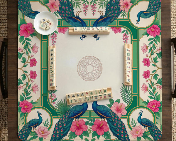Green mahjong mat with peacocks, hibiscus flowers, tropical leaves, cream center space, and a scalloped floral border.