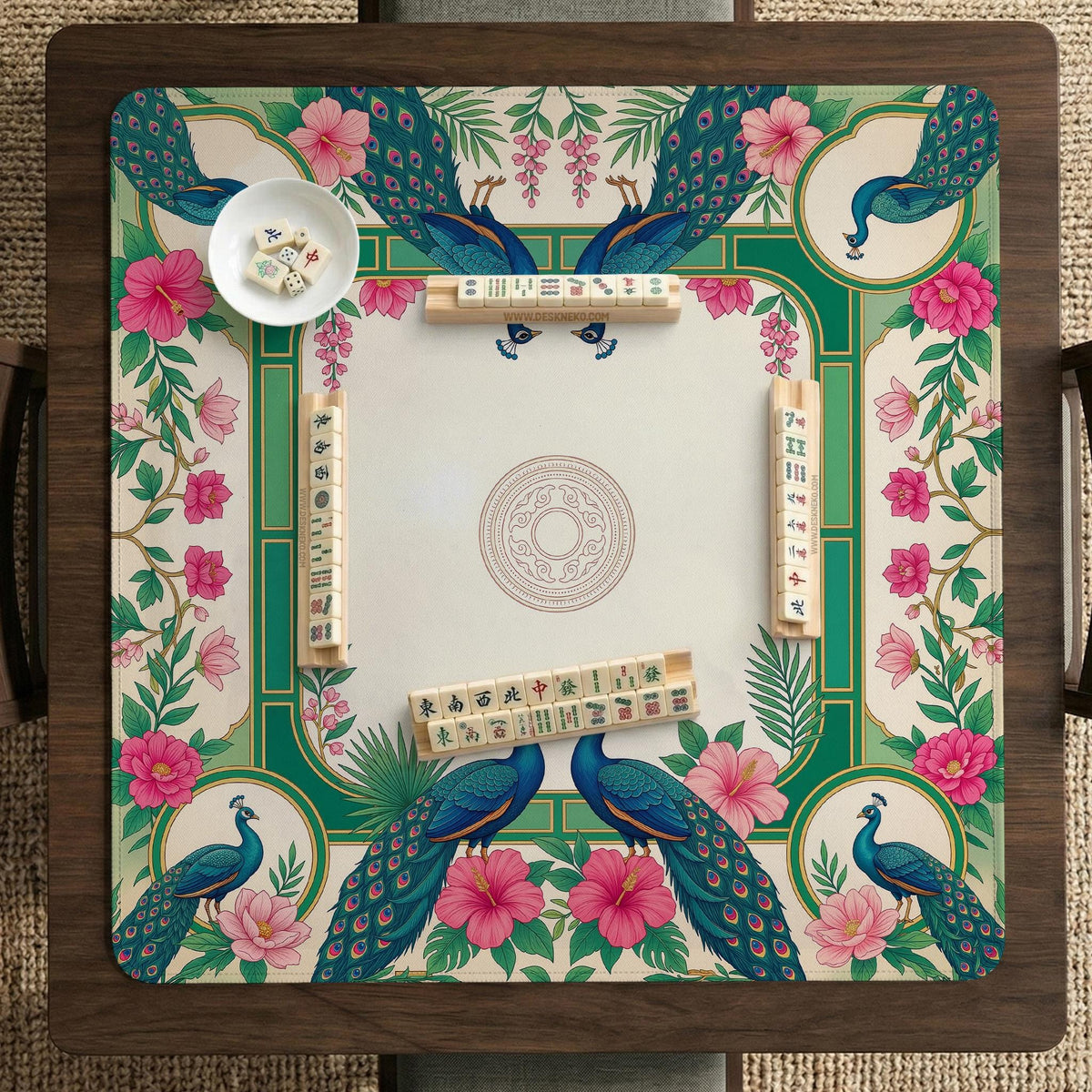 Green mahjong mat with peacocks, hibiscus flowers, tropical leaves, cream center space, and a scalloped floral border.