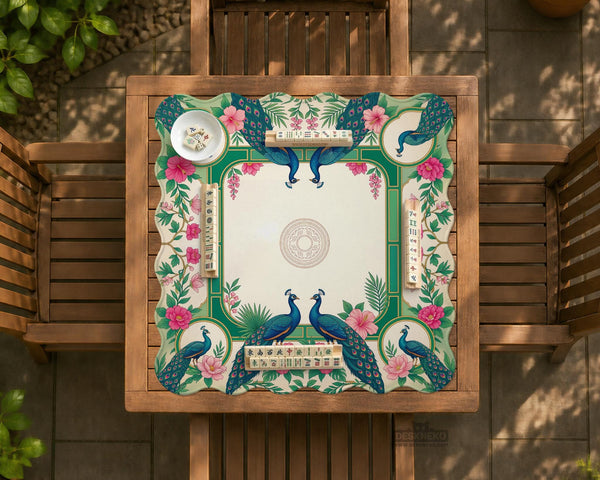 Green mahjong mat with peacocks, hibiscus flowers, tropical leaves, cream center space, and a scalloped floral border.