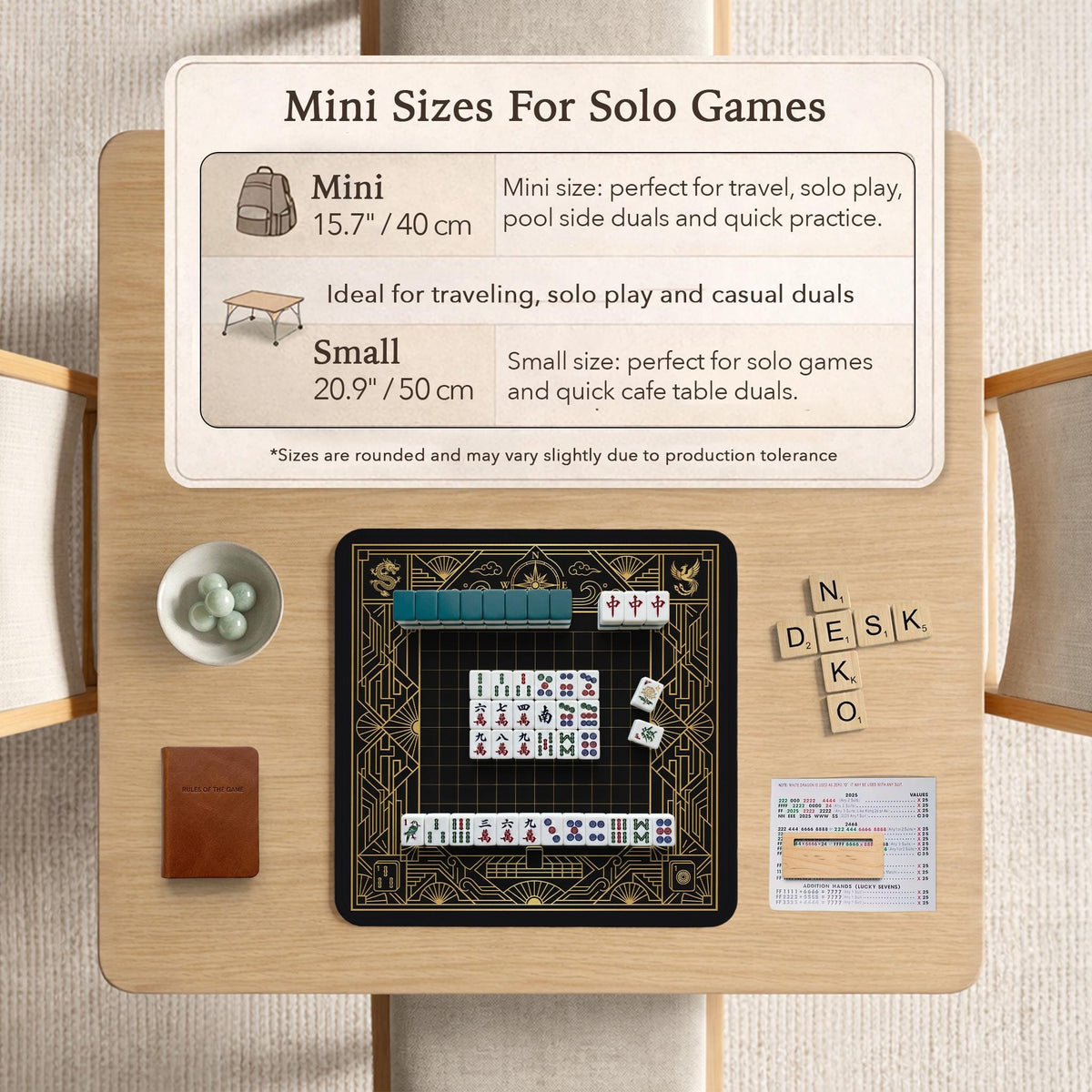 Black and gold square mahjong mat with a scalloped edge, geometric border, thin line details, fan motifs, and dragon and phoenix accents around an open center.