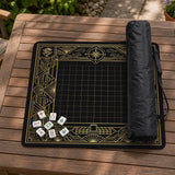 Black and gold square mahjong mat with a scalloped edge, geometric border, thin line details, fan motifs, and dragon and phoenix accents around an open center.
