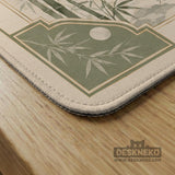 Square mahjong mat with a sage green bamboo and mountain design, cream center, scalloped border details, and gold line accents.