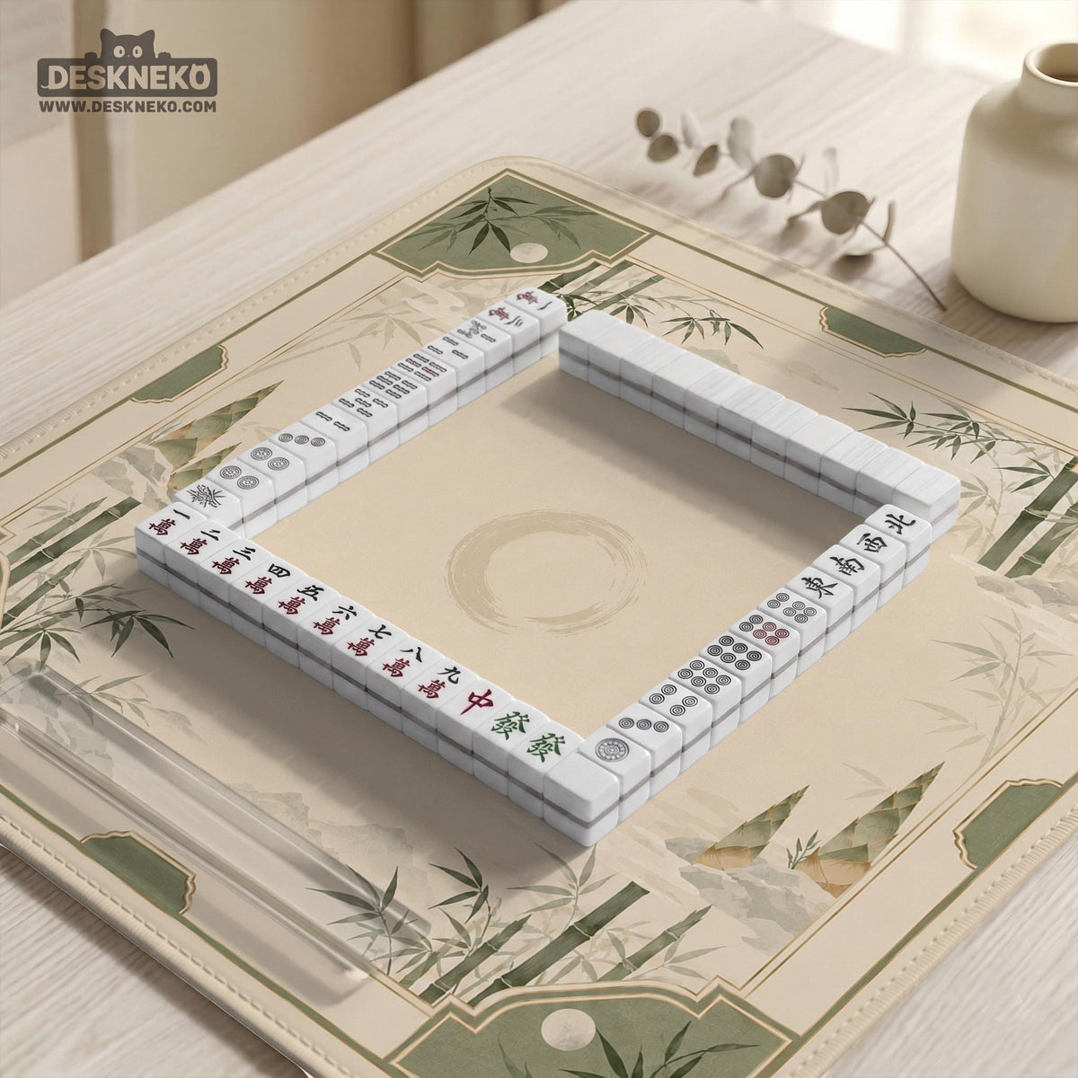 Square mahjong mat with a sage green bamboo and mountain design, cream center, scalloped border details, and gold line accents.