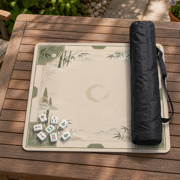 Square mahjong mat with a sage green bamboo and mountain design, cream center, scalloped border details, and gold line accents.