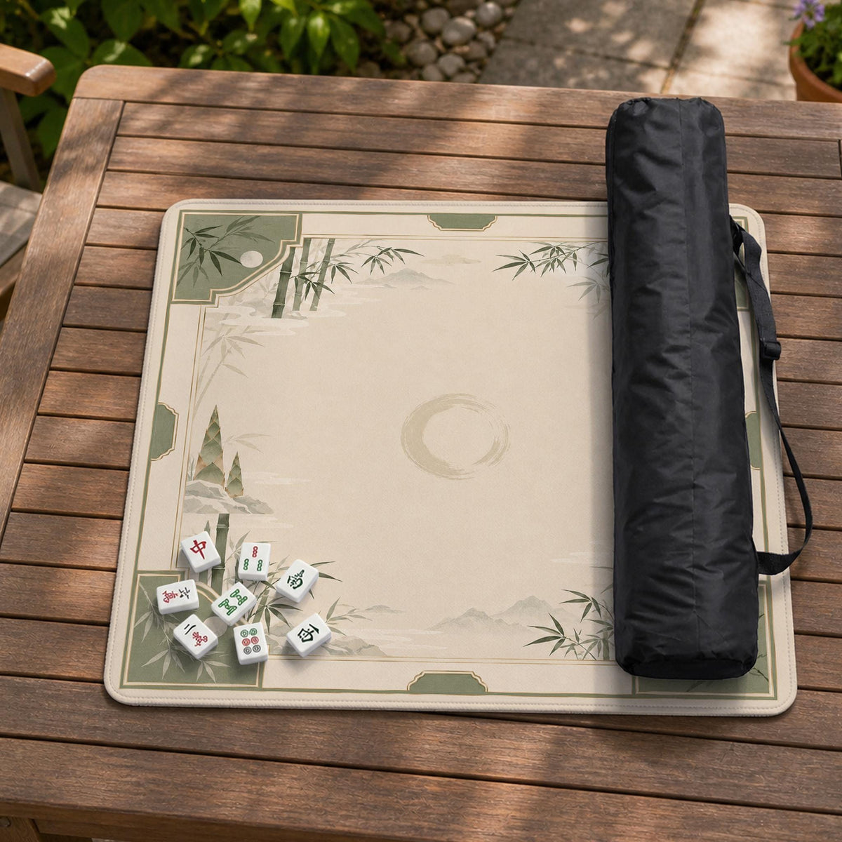 Square mahjong mat with a sage green bamboo and mountain design, cream center, scalloped border details, and gold line accents.
