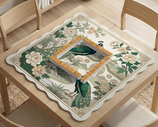 A green mahjong mat with peacock, floral, bamboo, pagoda, and gold border artwork in a scalloped chinoiserie style.