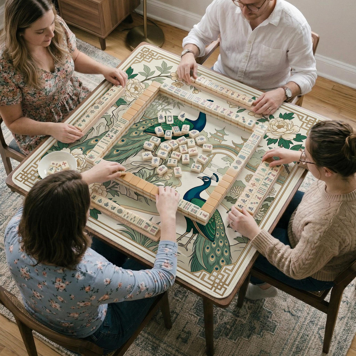 A green mahjong mat with peacock, floral, bamboo, pagoda, and gold border artwork in a scalloped chinoiserie style.