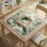 A green mahjong mat with peacock, floral, bamboo, pagoda, and gold border artwork in a scalloped chinoiserie style.