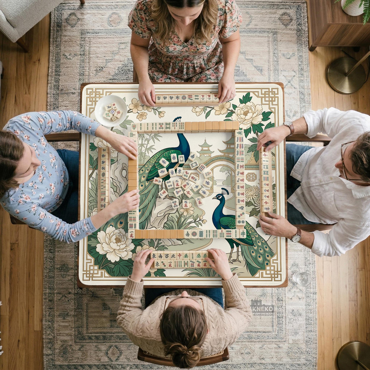 A green mahjong mat with peacock, floral, bamboo, pagoda, and gold border artwork in a scalloped chinoiserie style.