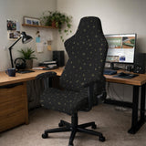 Desk chair cover in black with a small gold star pattern shown on a swivel chair.