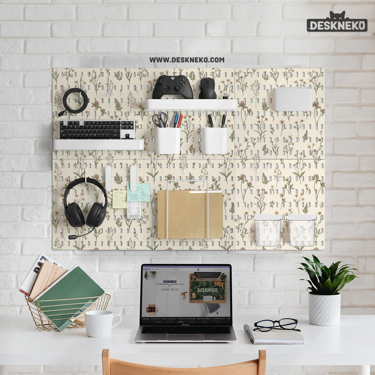 Cream pegboard wall organizer with small floral print, sage green stems, black slot layout, shelves, hooks, clips, and containers.