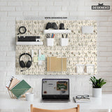 Cream pegboard wall organizer with small floral print, sage green stems, black slot layout, shelves, hooks, clips, and containers.