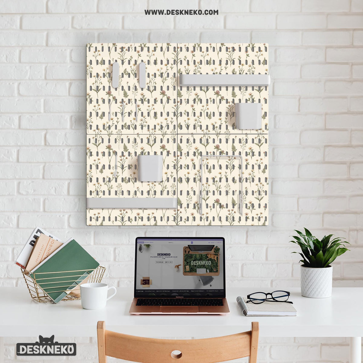 Cream pegboard wall organizer with small floral print, sage green stems, black slot layout, shelves, hooks, clips, and containers.