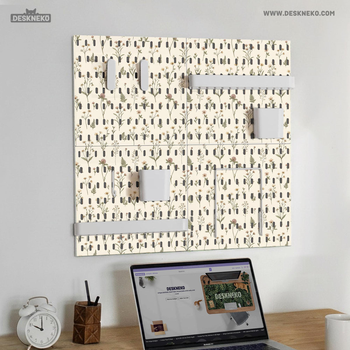 Cream pegboard wall organizer with small floral print, sage green stems, black slot layout, shelves, hooks, clips, and containers.