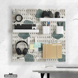 Four pegboard panels in sage green with cream, grey, teal, and leafy botanical artwork arranged in a square layout.