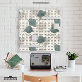 Four pegboard panels in sage green with cream, grey, teal, and leafy botanical artwork arranged in a square layout.