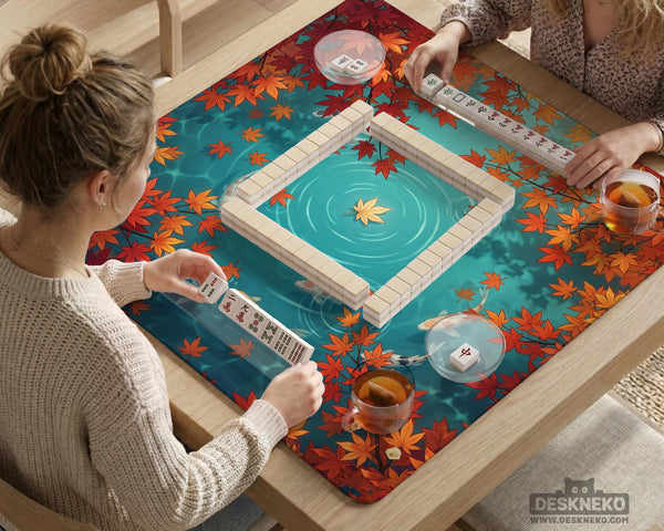 Square teal mahjong mat with koi fish, falling autumn leaves, and pond water artwork.