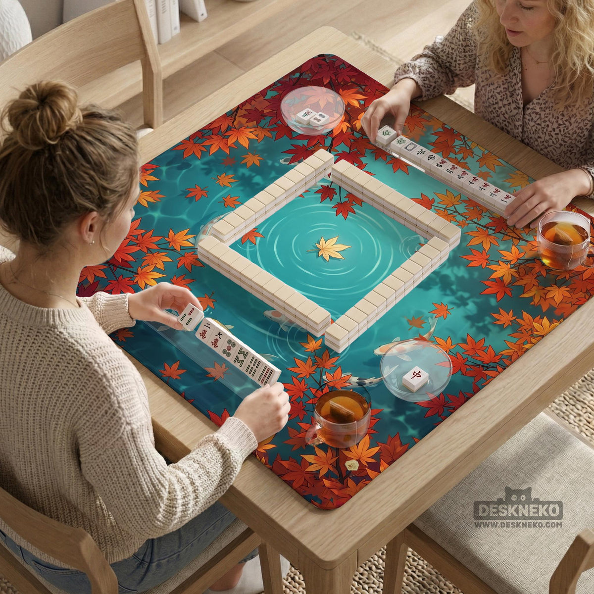 Square teal mahjong mat with koi fish, falling autumn leaves, and pond water artwork.
