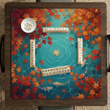 Square teal mahjong mat with koi fish, falling autumn leaves, and pond water artwork.