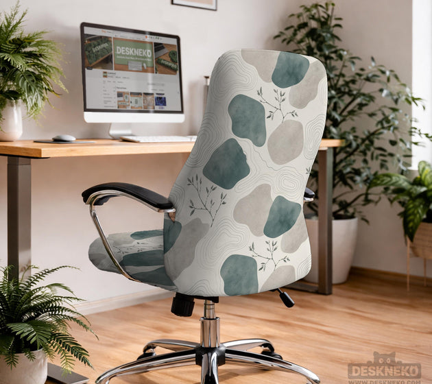 Chair cover with a cream background, muted sage abstract shapes, grey organic forms, and small botanical accents.