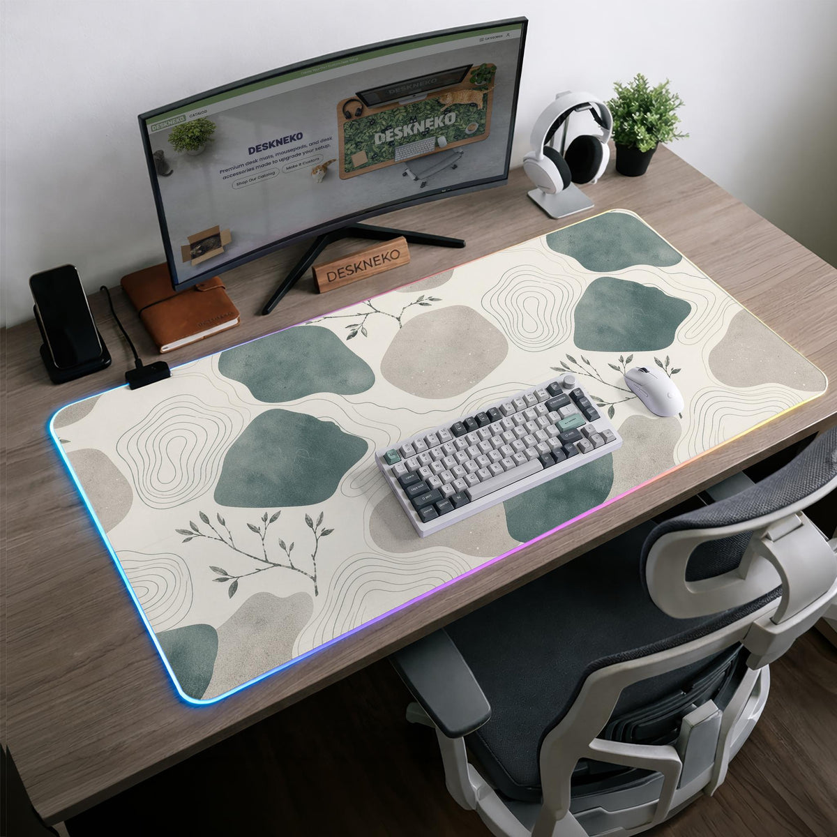 A desk mat with sage green abstract blocks, cream space, gray stone-like shapes, fine topographic contour lines, and small branch details.