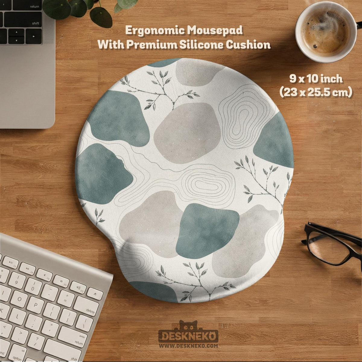 A desk mat with sage green abstract blocks, cream space, gray stone-like shapes, fine topographic contour lines, and small branch details.