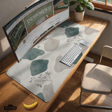 A desk mat with sage green abstract blocks, cream space, gray stone-like shapes, fine topographic contour lines, and small branch details.
